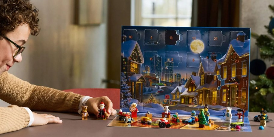 boy playing with lego city advent calendar on table