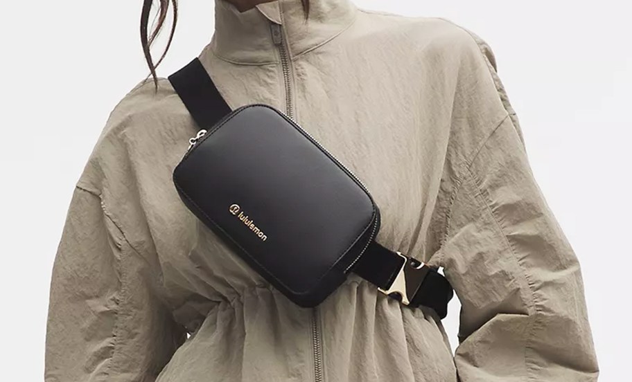 woman with a black leather belt bag with gold hardware