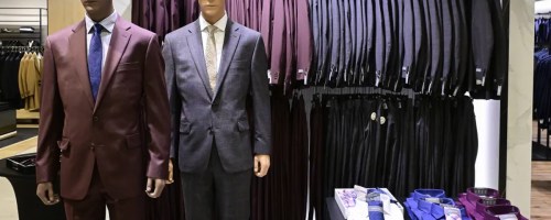 mannequins and suits hanging in store