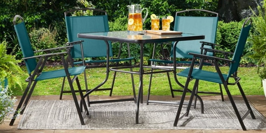 teal and black patio dining set outdoors 