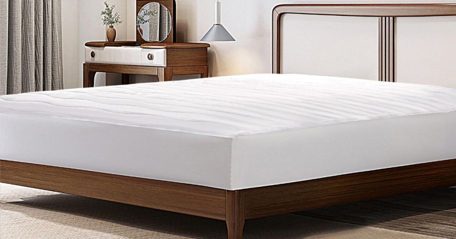 bed with white mattress pad on it