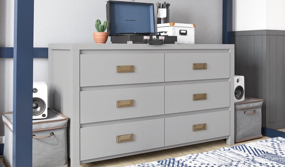 a gray chest of drawers