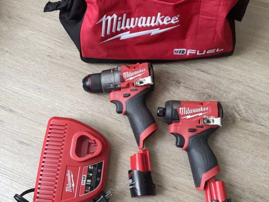 red and black milwaukee bag with tools laying on table