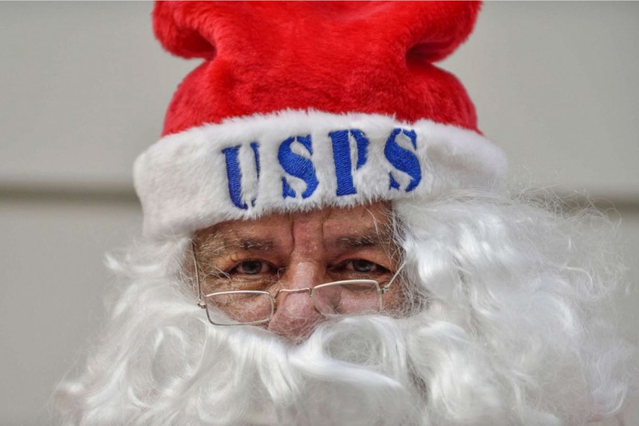 santa wearing usps on hat