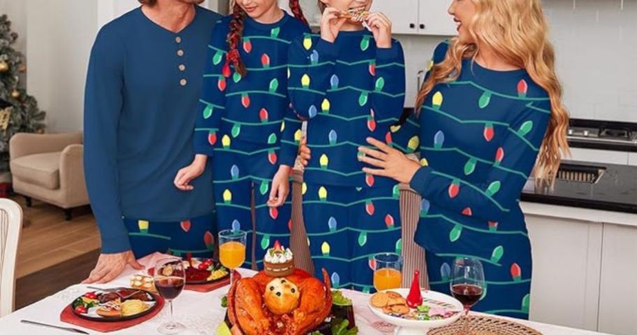 family standing in kitchen wearing matching pajamas