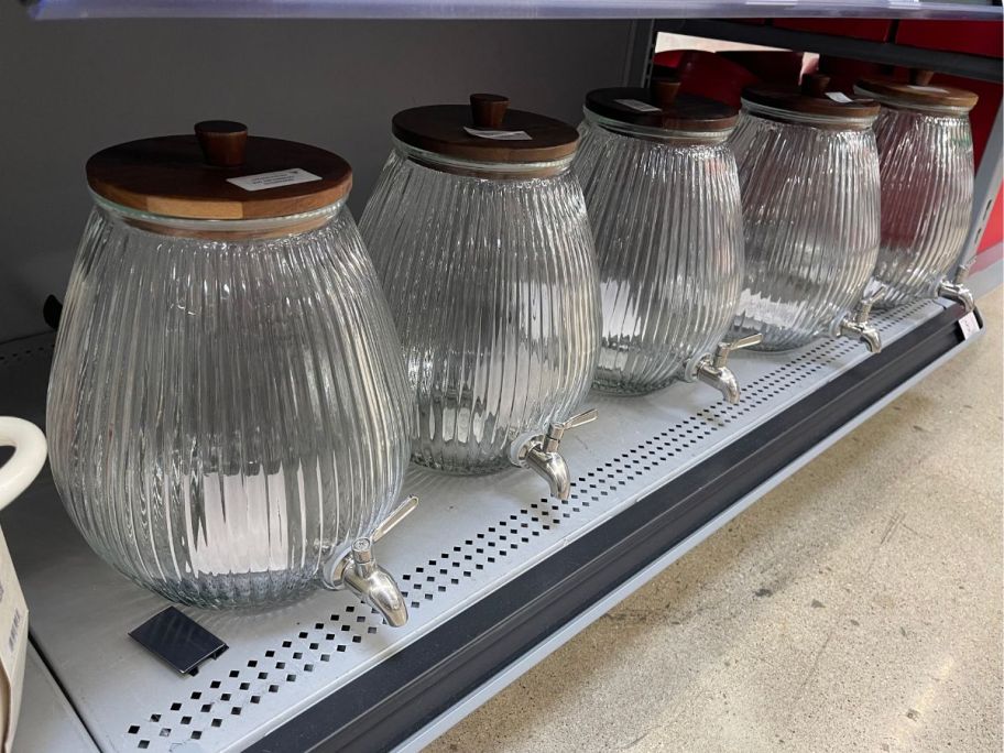 The Pioneer Woman Glass 2-Gallon Ribbed Beverage Dispensers on shelf in store