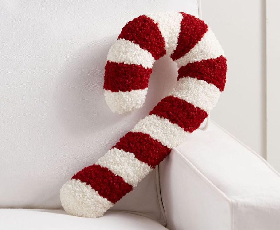 red and white candy cane pillow on white couch