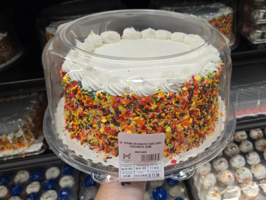 fall decorated cake in hand in store