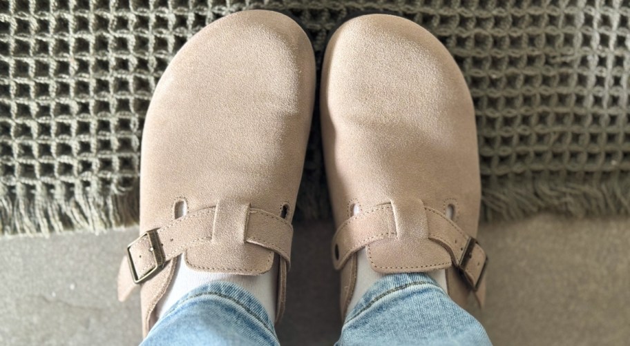 womans feet in a pair of sonoma suede clogs in tan