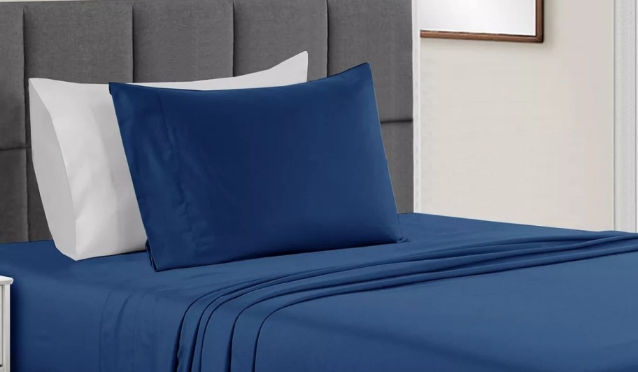 navy blue microfiber sheet set on a bed