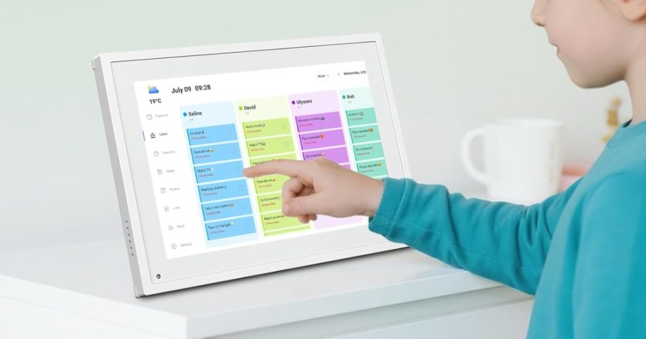 a little girl touching the screen of a digital smart calendar