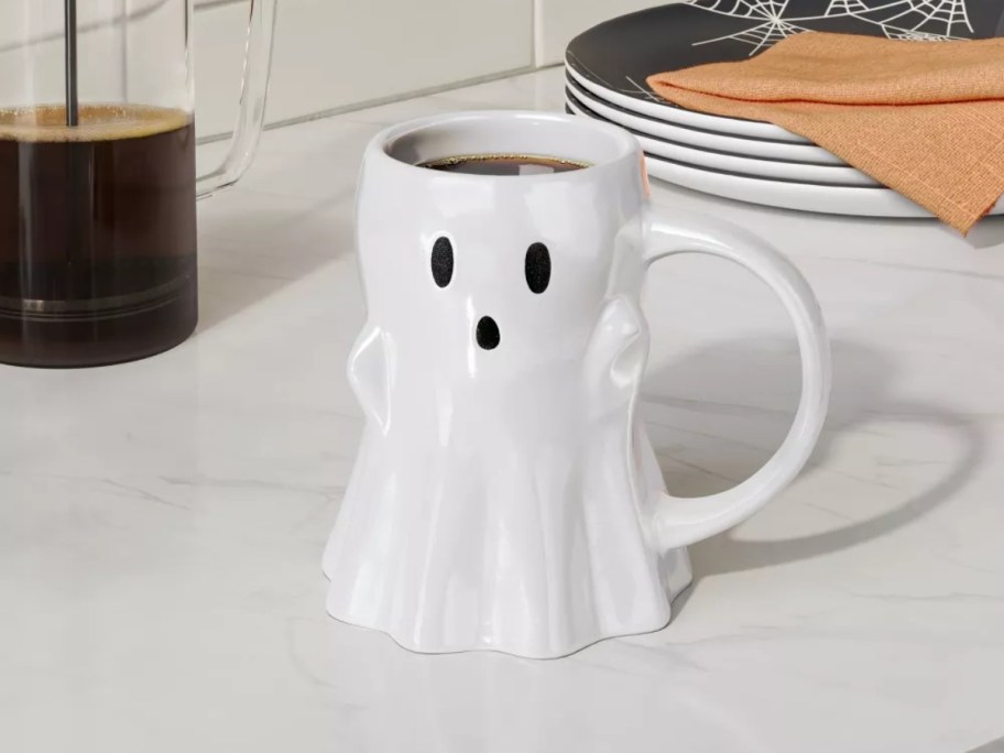 a large ghost coffee mug on a kitchen counter