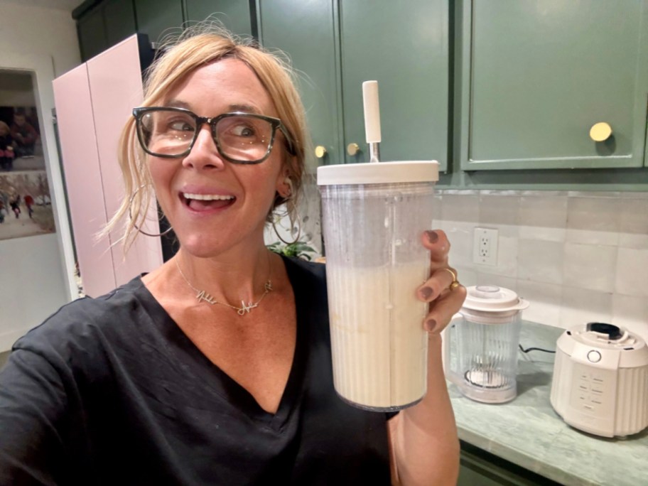 collin holding white glass tumbler with straw