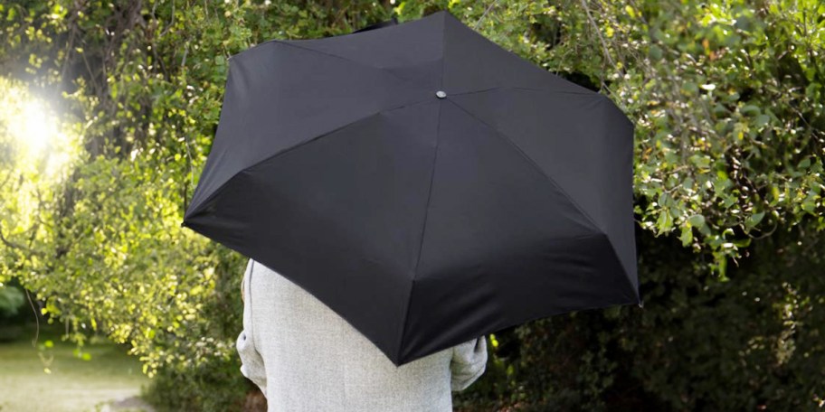 person holding black umbrella 