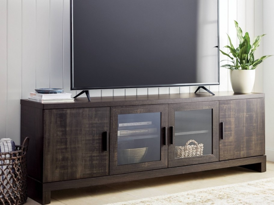 wooden tv stand with a tv sitting on it
