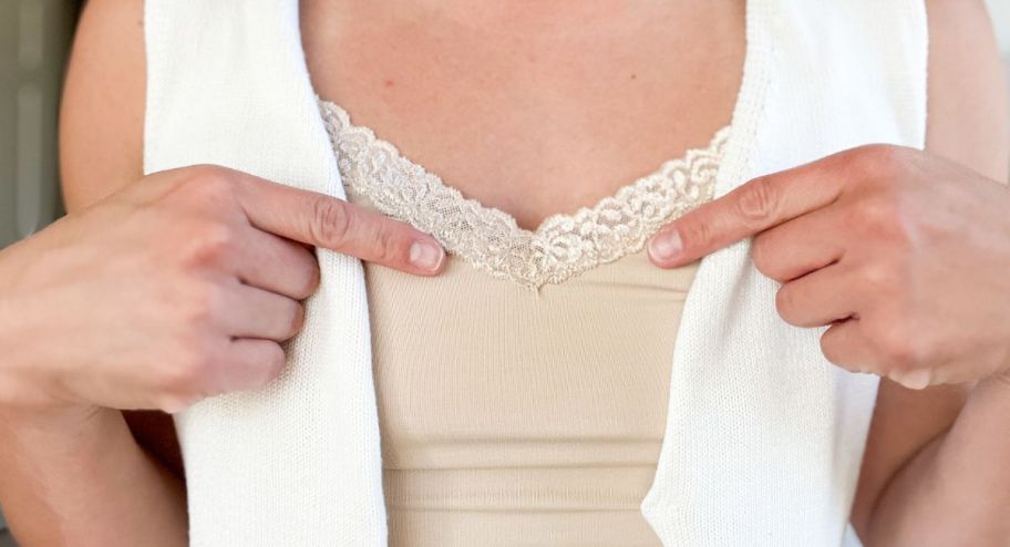 woman pointing to design on vanity fair cami