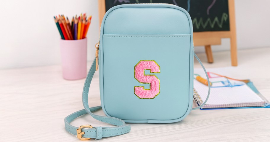 blue crossbody bag with letter s on it