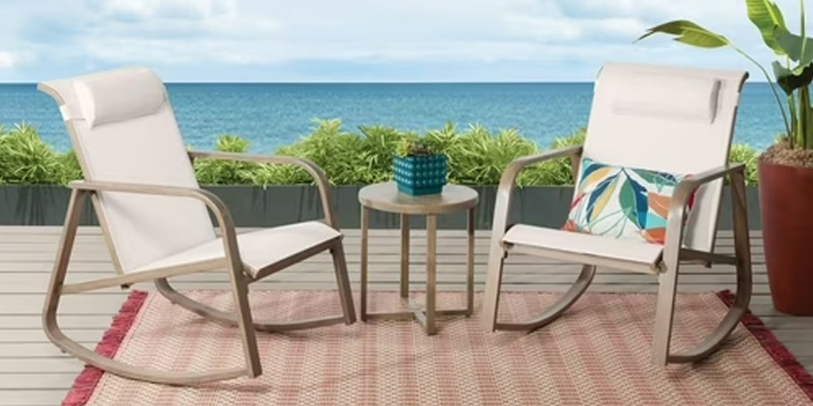 two beige rocking chairs and matching table on patio 