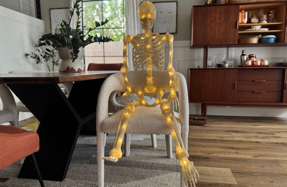light up skeleton on chair in dining room