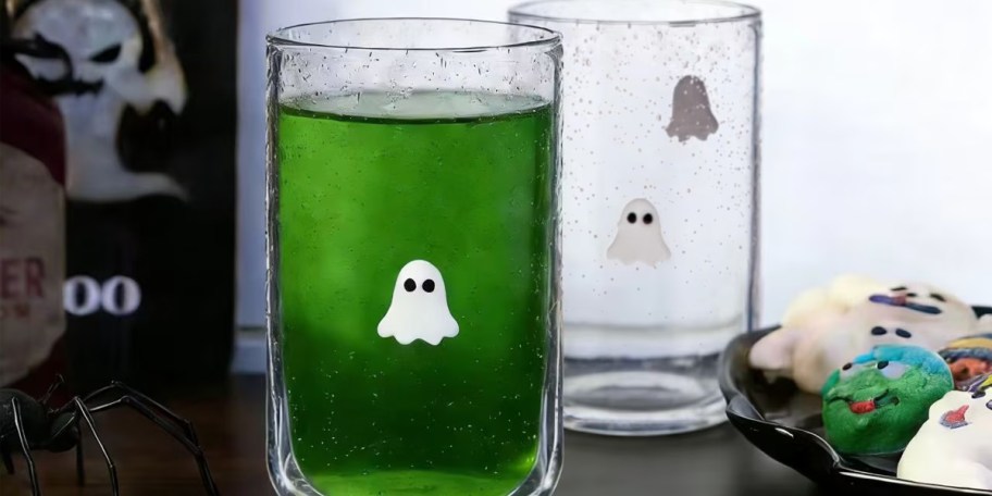 glass ghost cups on table with green drink in cup 