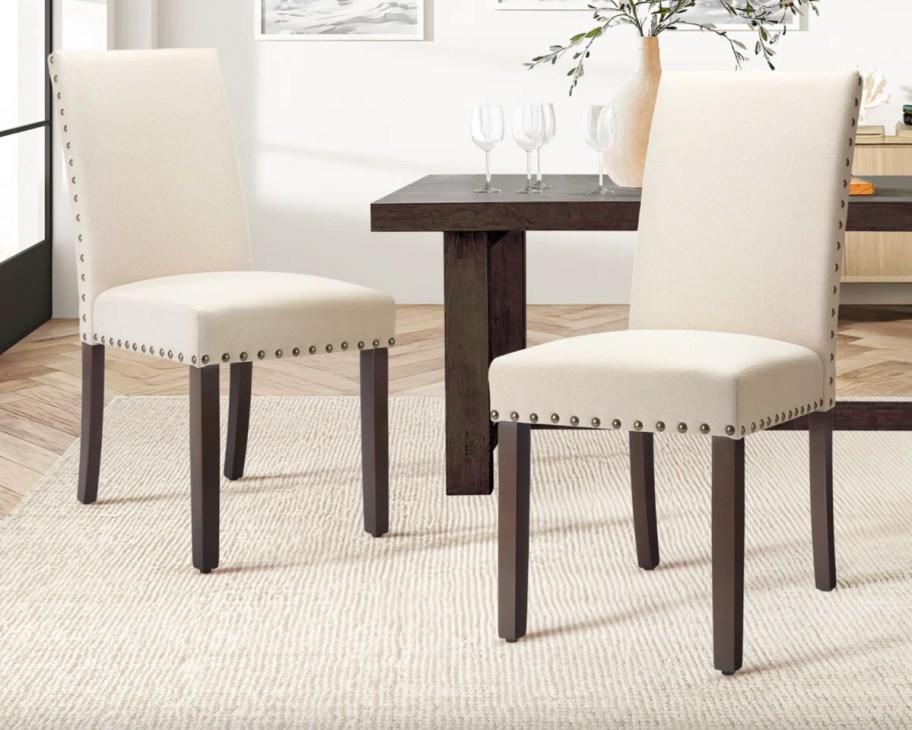 two cream dining chairs