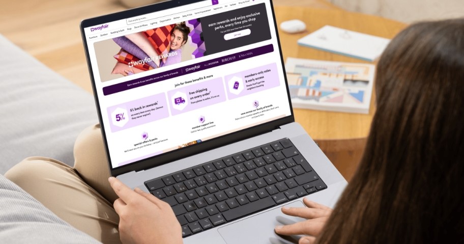 Woman typing on laptop with Wayfair rewards 