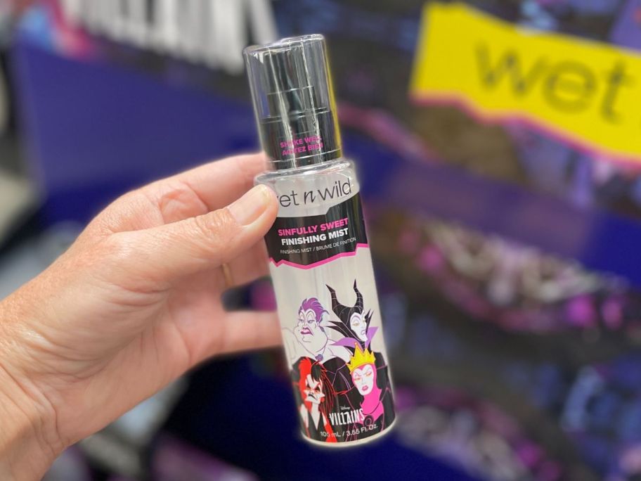 Wet N Wild Disney Villains Sinfully Sweet Finishing Mist in hand in store