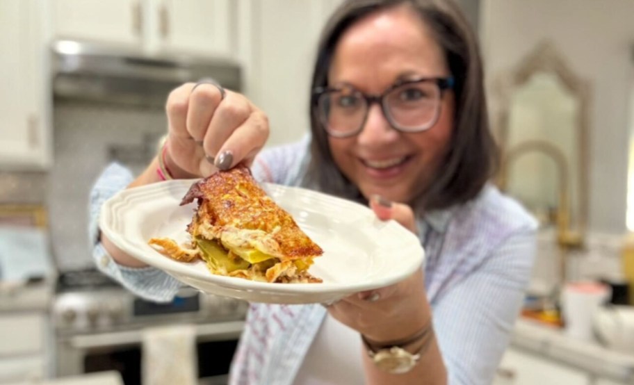 woman holding a chicken pickle sandwich