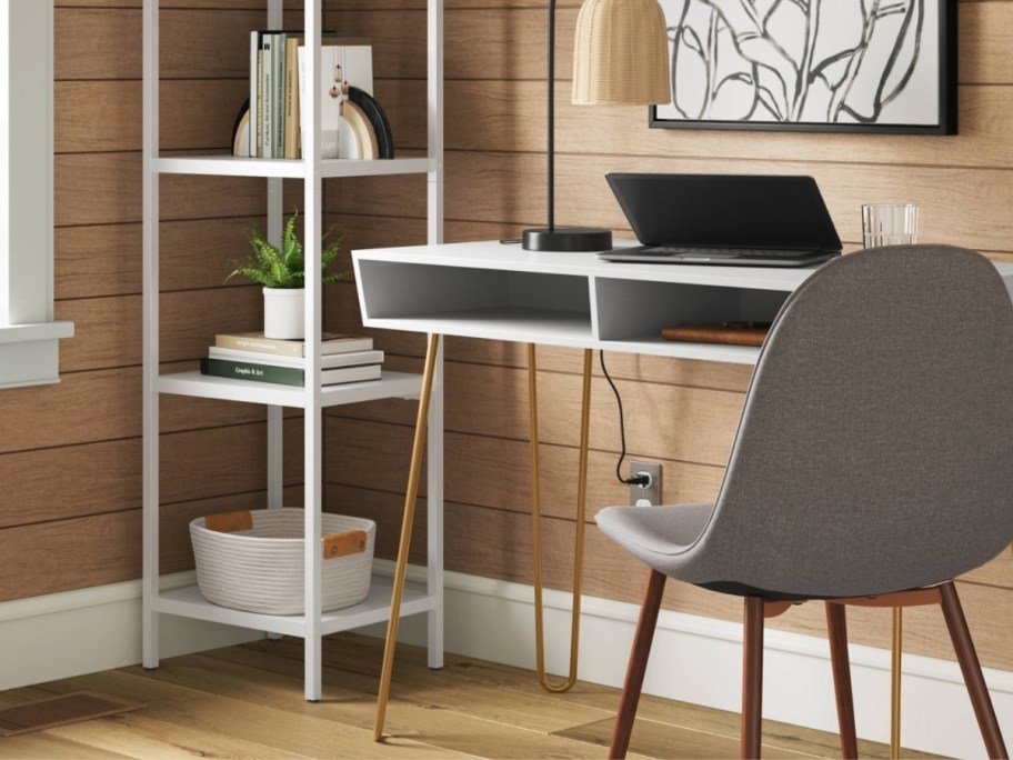 a white desk with hairpin legs shown with a chair