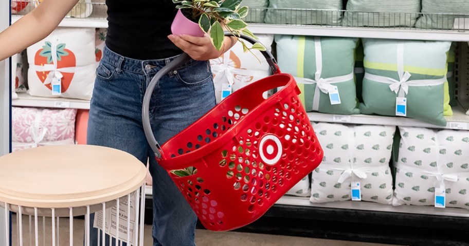 woman holding a Target shopping basket in the home section of the store
