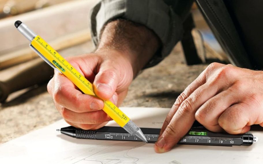 men using WEARXI 9-in-1 Multitool Pen on a paper