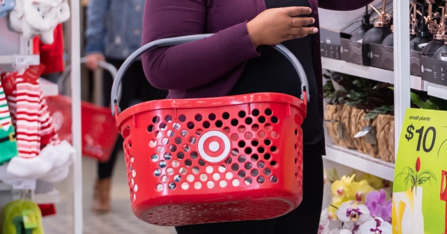 person holding a Target shopping basket in a Target store