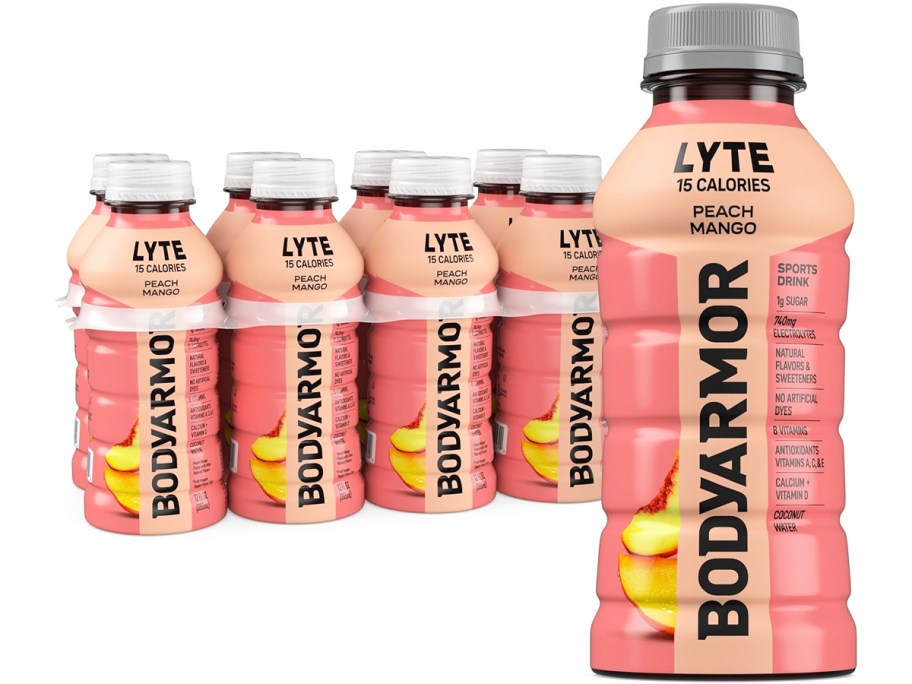 bottle of BODYARMOR Lyte in peach mango flavor in front of a case of more bottles