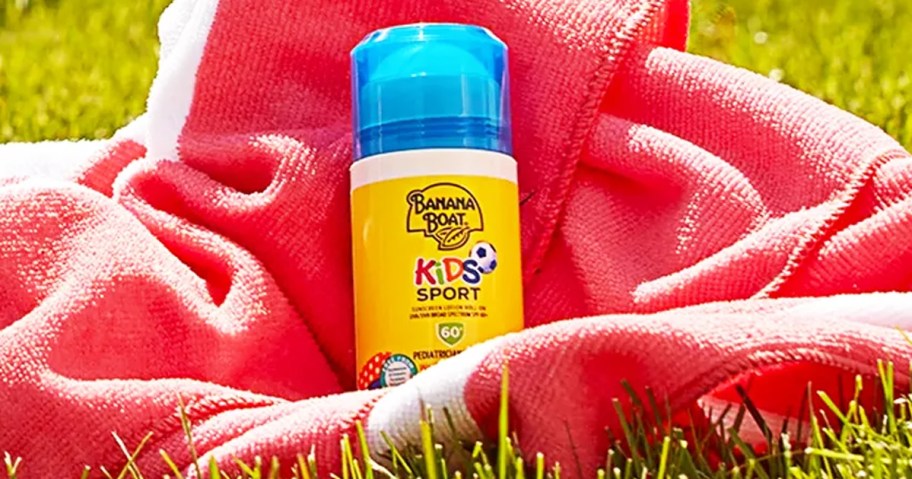 bottle of Banana Boat Sport Kids Roll-On Sunscreen in a pink towel