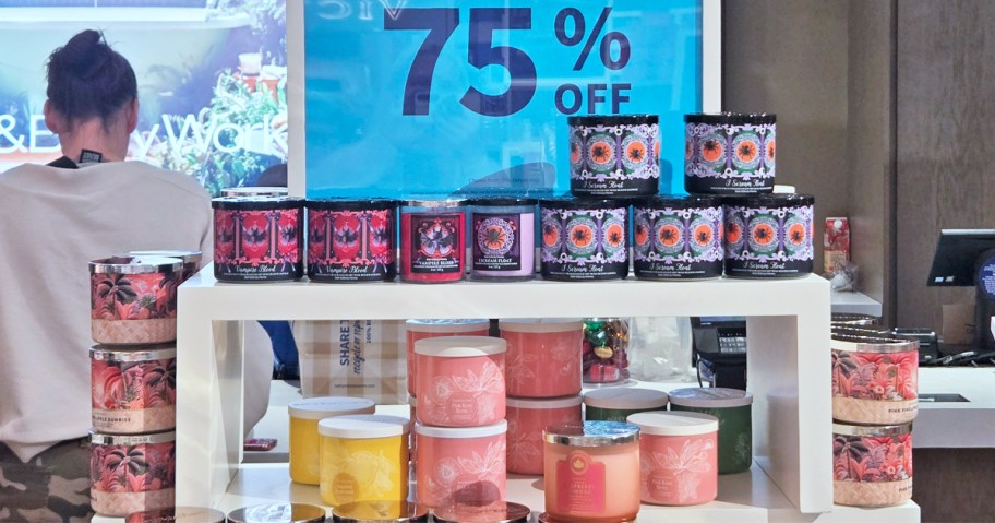 display table of 3-wick candles with 75% off sign