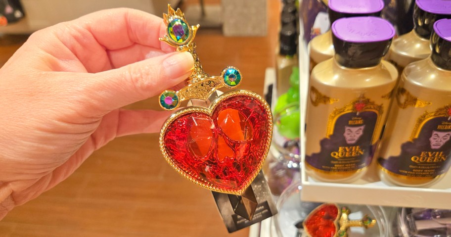 hand holding a pierced heart Bath & Body Works Wallflower Plug