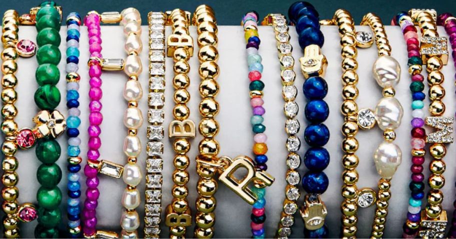 Several bracelets with shiny letters and colorful beads