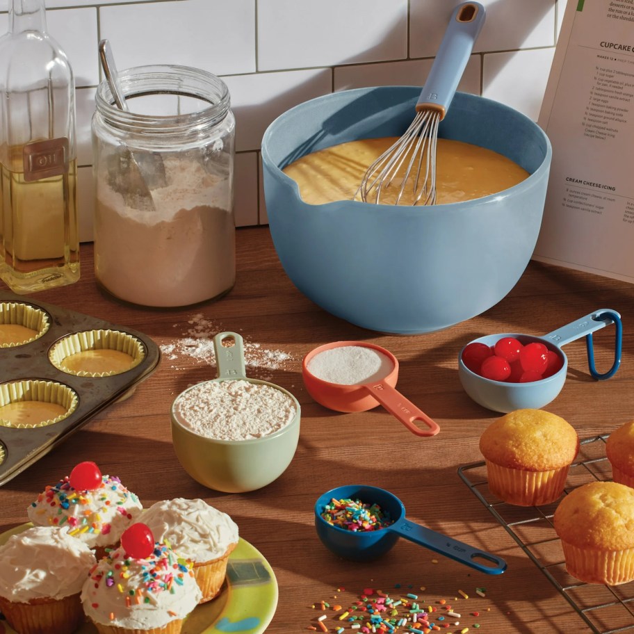 baking set on counter with baking ingredients and cupcakes