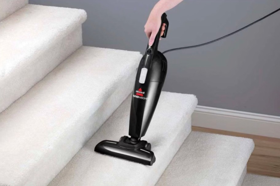 hand vacuuming carpet stairs with small bissell