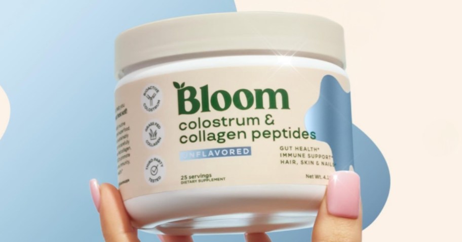 person holding container of bloom nutrition colostrum and collagen peptides
