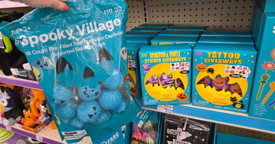 A bag of Teal Halloween Pumpkins and boxes of halloween non-food treats