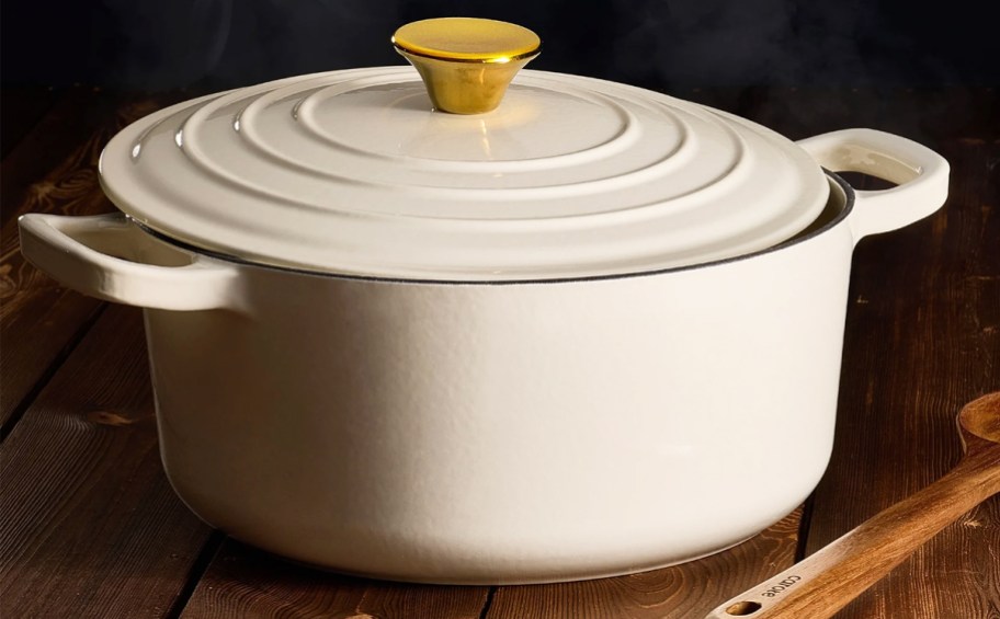 white dutch oven with matching lid with a gold knob