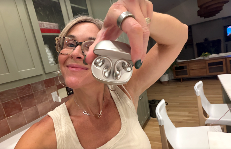 woman holding joyroom earbuds