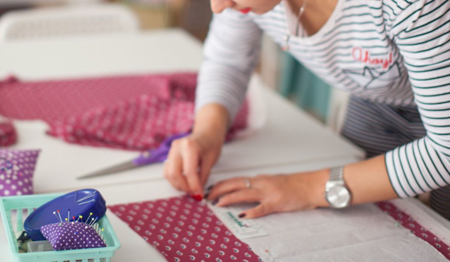 Woman getting ready to sew and pinning her fabric
