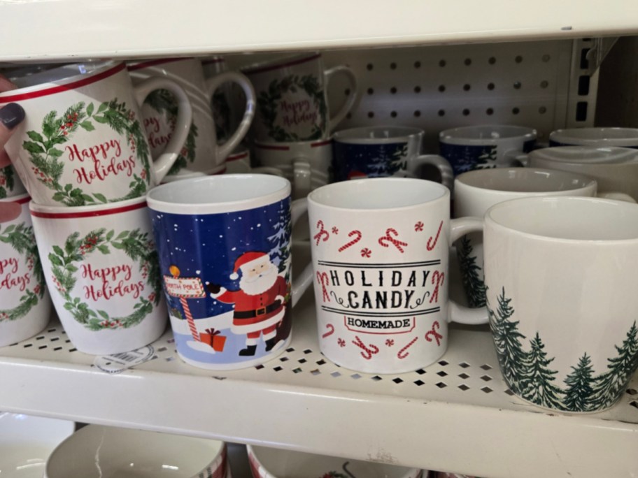 Christmas mugs on a shelf at Dollar Tree.