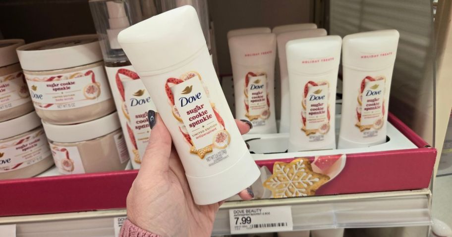 A person holding Dove deodorant in a store