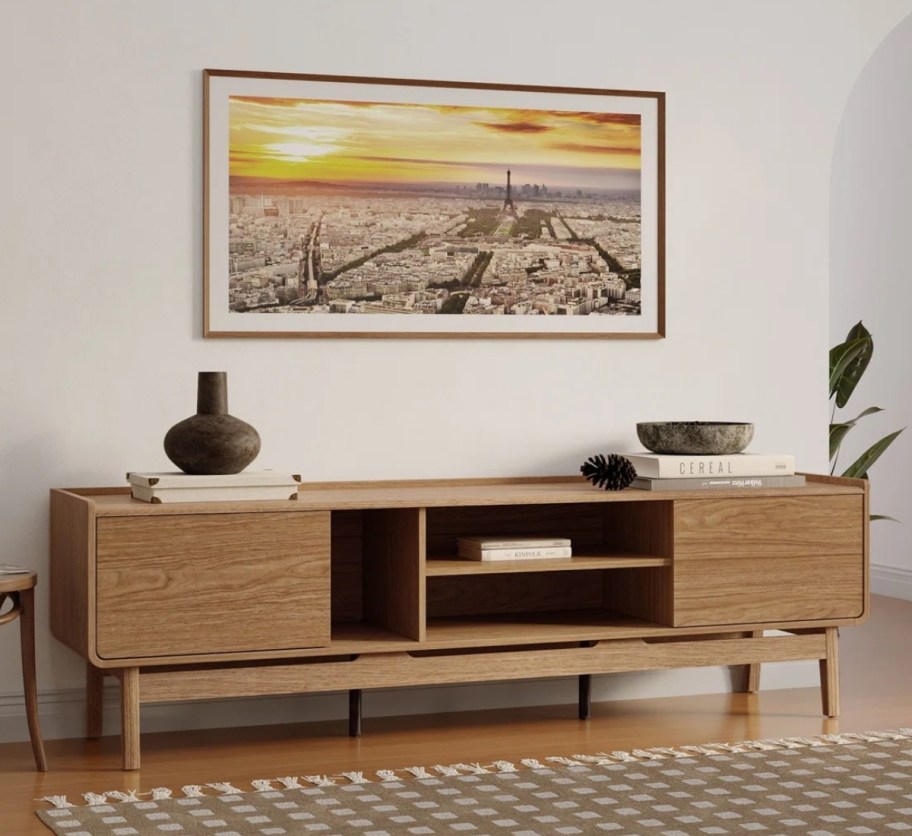 credenza with accessories and a paiting hung above