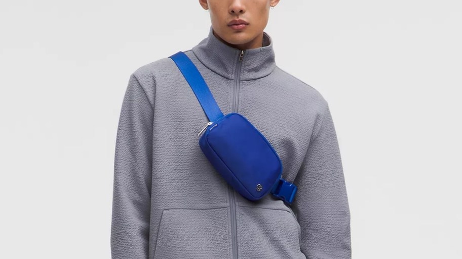 man with a blue belt bag