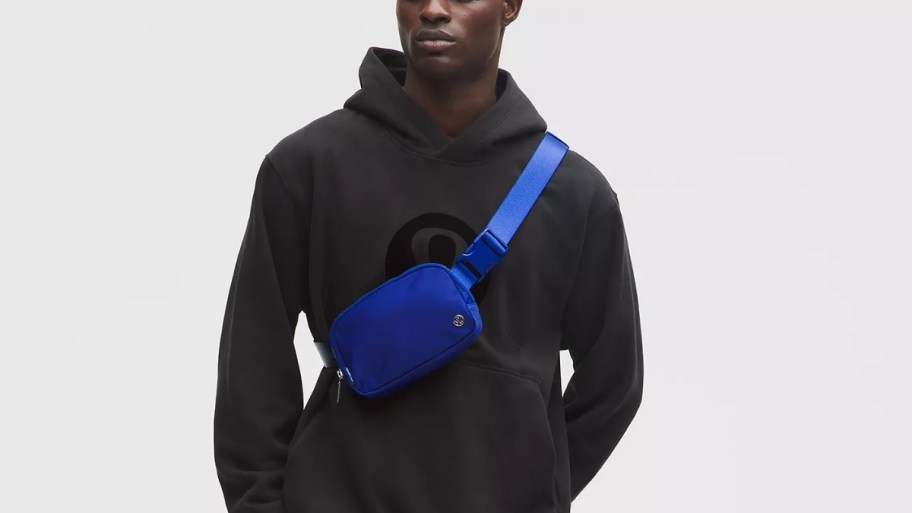 man with a blue belt bag