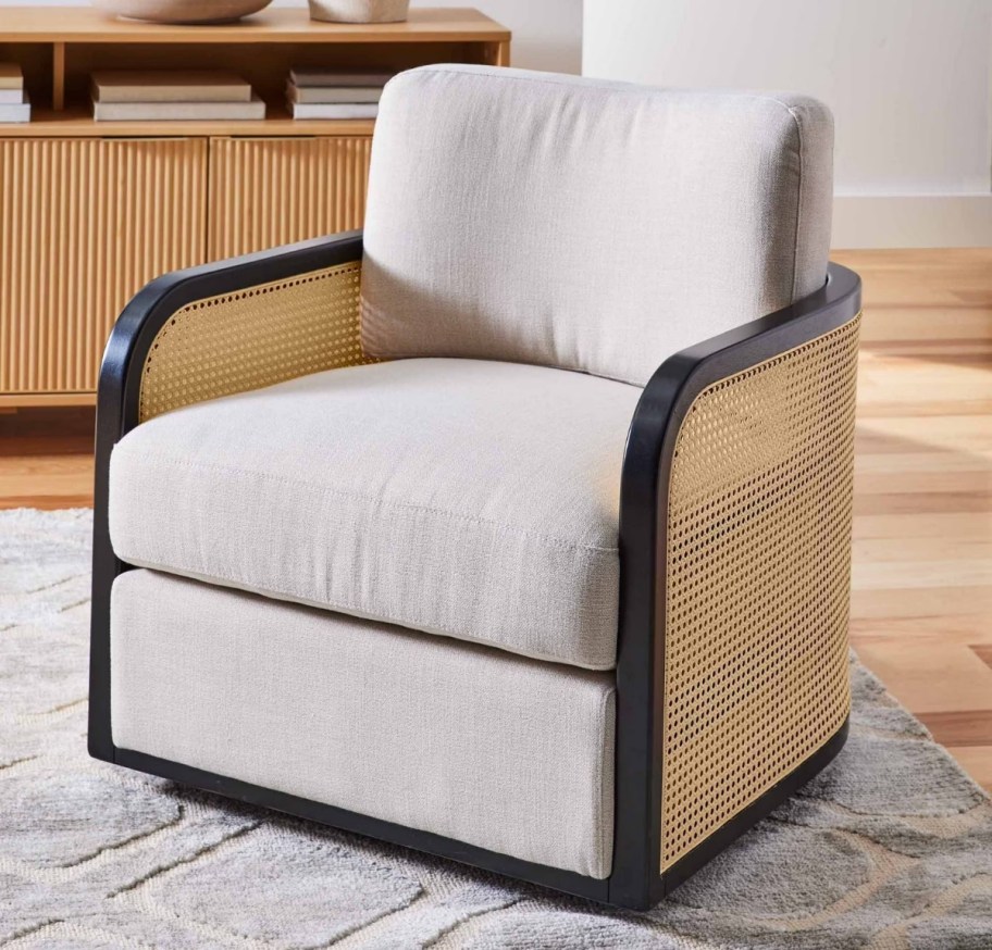 a cane swivel chair with beige linen upholstery